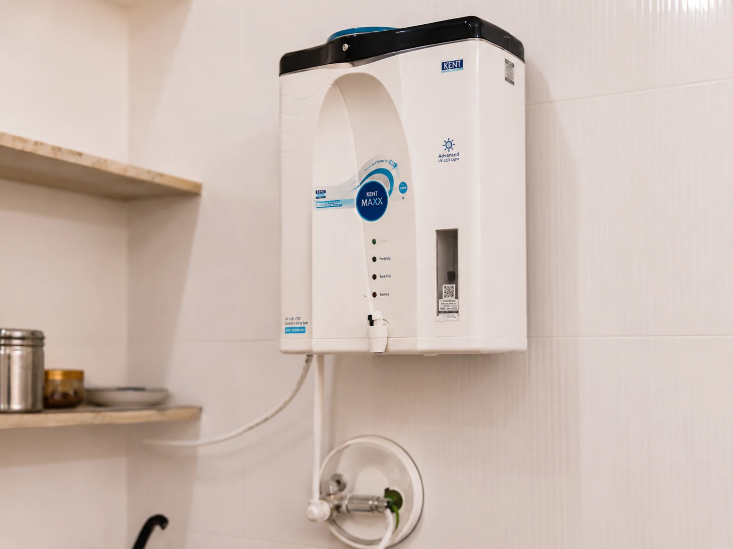 Wall-mounted water purifier above the kitchen sink area.