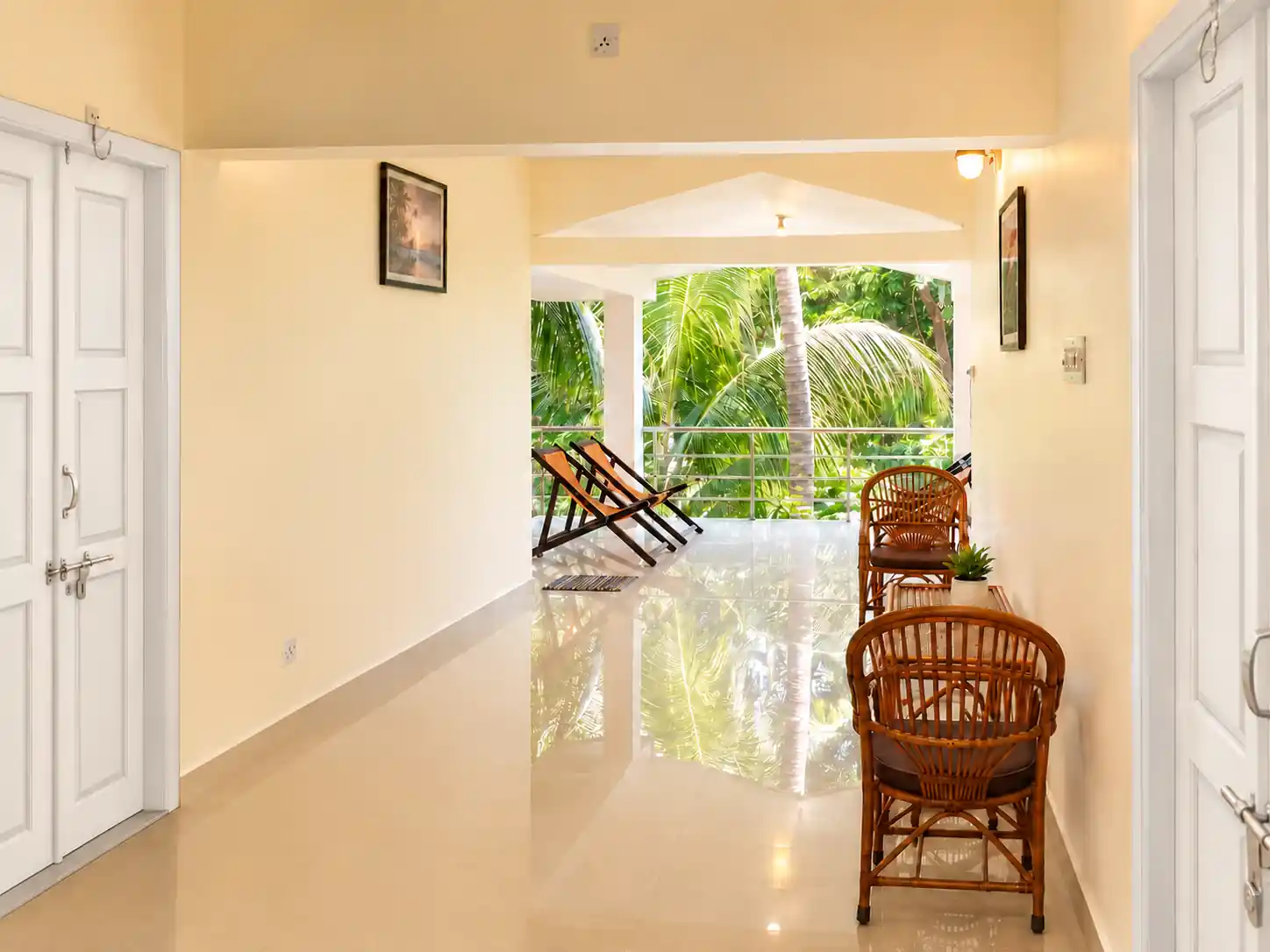 Central hall toward the balcony, with Nidhi entrance on the left, SriNidhi entrance on the right and cane seating.