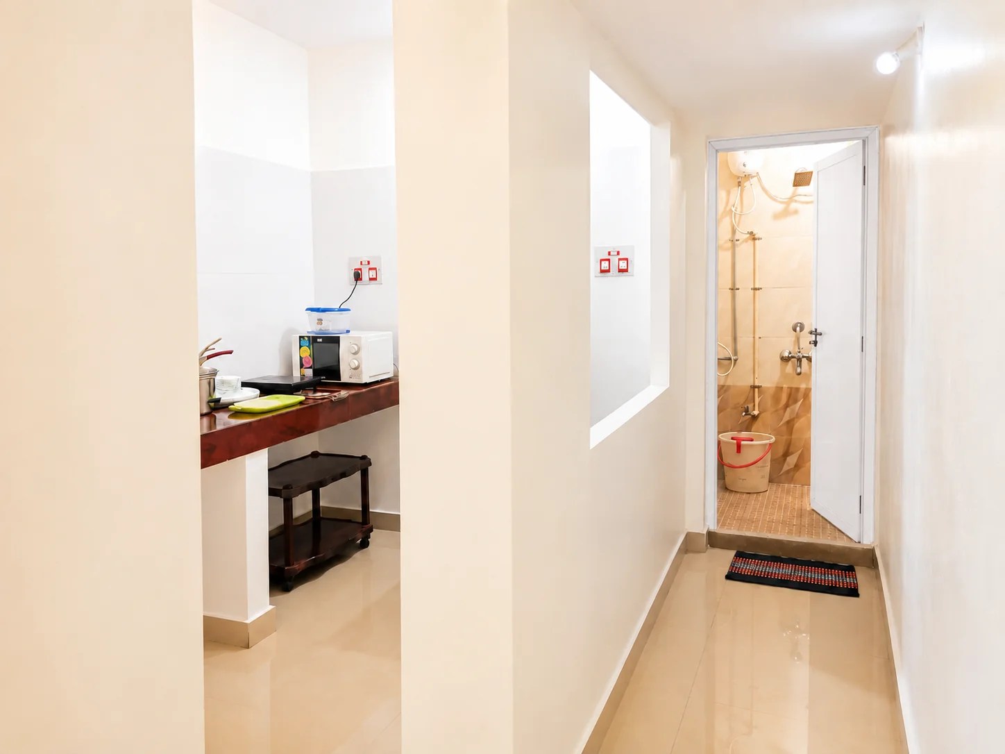 Passage with kitchen opening and bathroom doorway in SriNidhi apartment.