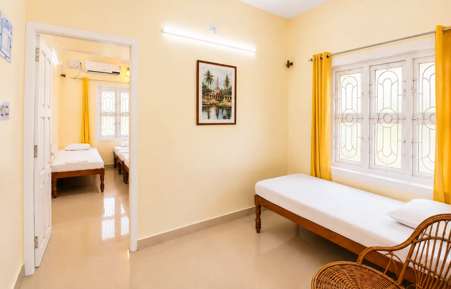 Single bed, chair and bedroom doorway in SriNidhi apartment.